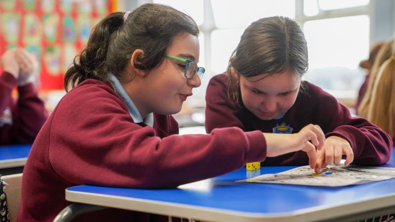 Children playing at a desk